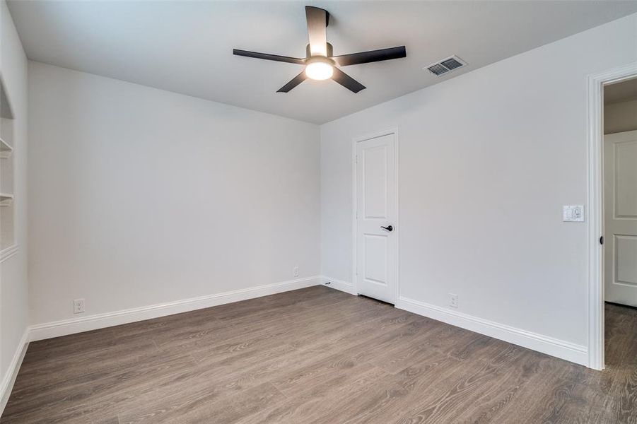 Bedroom featuring ceiling fan and wood-type flooring