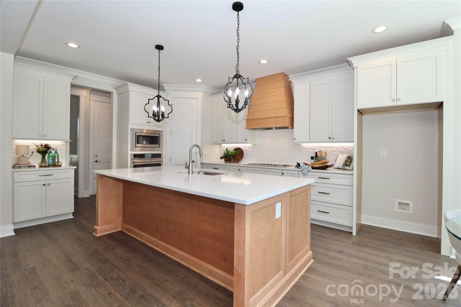 A gorgeous chef-inspired kitchen with Quartz countertops featuring a large center island. Ideal for gatherings and entertainment. A gorgeous chef-inspired kitchen with Quartz countertops featuring a large center island. Ideal for gatherings and entertainment.