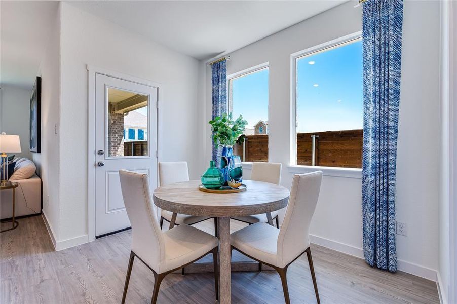 Dining room with light hardwood / wood-style flooring and plenty of natural light