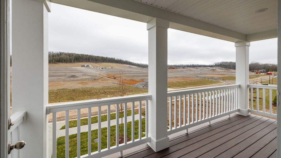 Covered balcony with fencing and columns, accessed from second floor