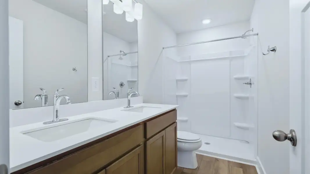Memorable mornings begin in this tasteful and thoughtfully crafted primary bathroom at Clarke Townes