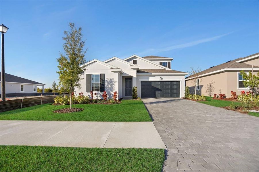 Front exterior of a new home in Turnleaf, Punta Gorda, FL, highlighting curb appeal (Image 22).