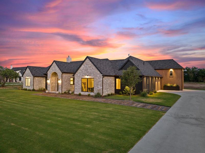 French country style house featuring a lawn