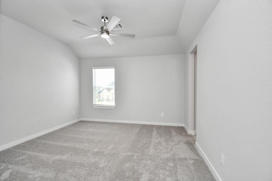 Secondary bedroom features plush carpeting, large windows that let in plenty of natural light, bright paint, and spacious closets.