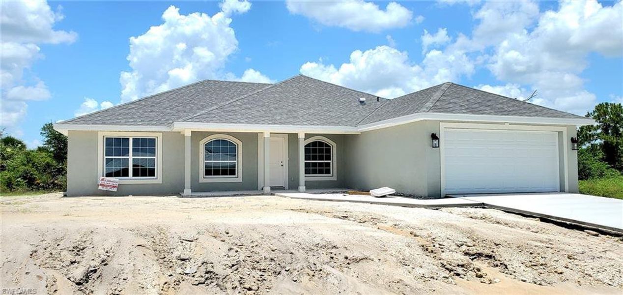 Front exterior of a new home in Lehigh Acres, Lehigh Acres, FL, highlighting curb appeal (Image 1).