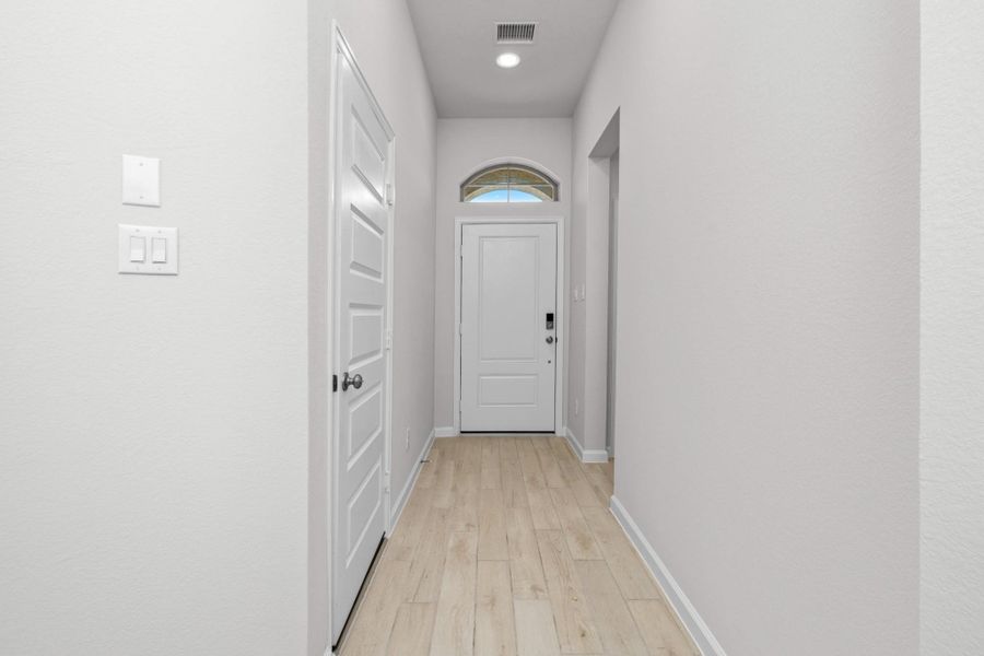Clean, bright entry hallway leading into the home's open living spaces.