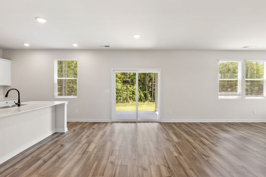 A room with a wood floor and a window with a wood floor. A room with a wood floor and a window with a wood floor.