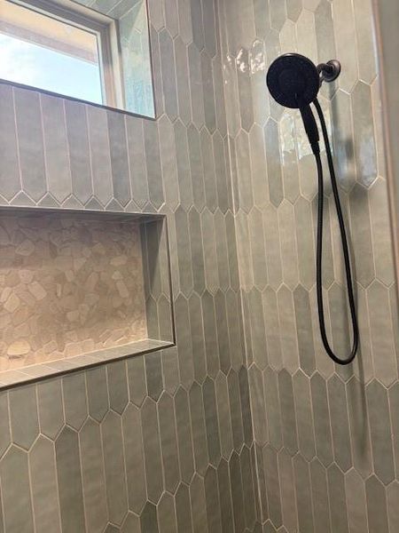 Full bath featuring tiled shower