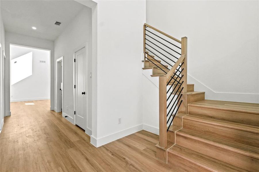 Stairs featuring baseboards and wood finished floors