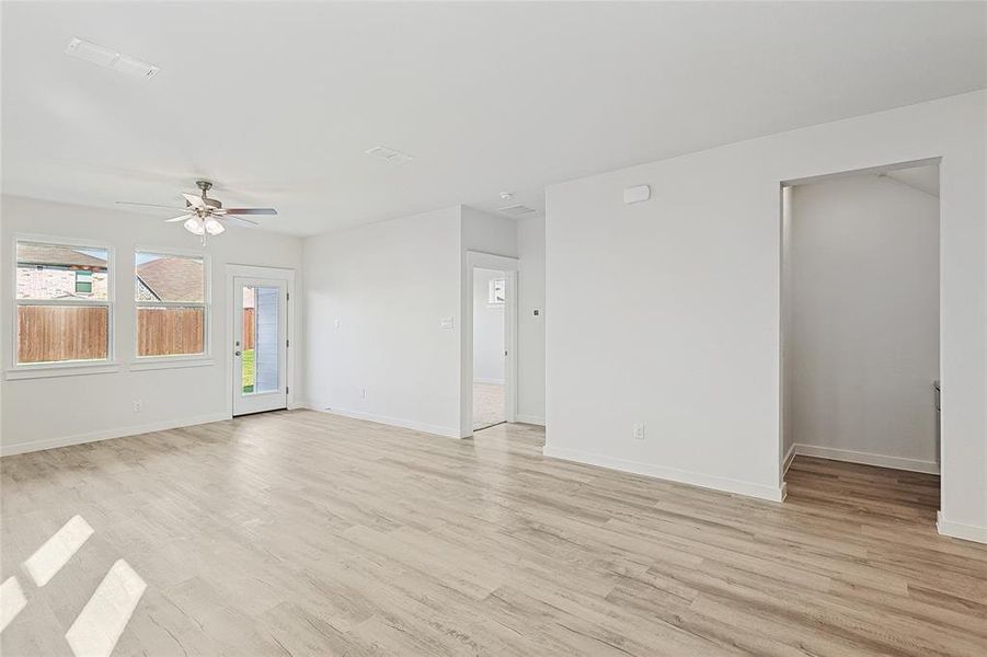 Empty room with light wood-type flooring and ceiling fan