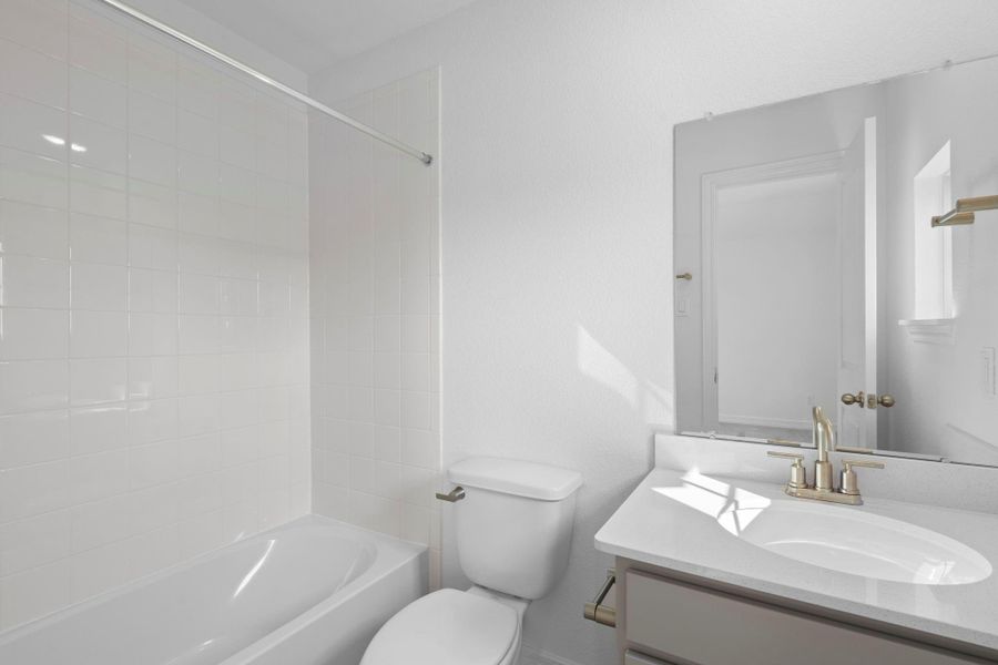 The secondary bath features tile flooring, white cabinetry and light countertops and a shower/tub combo. Perfect for accommodating any visiting family and friends. The secondary bath features tile flooring, white cabinetry and light countertops and a shower/tub combo. Perfect for accommodating any visiting family and friends.