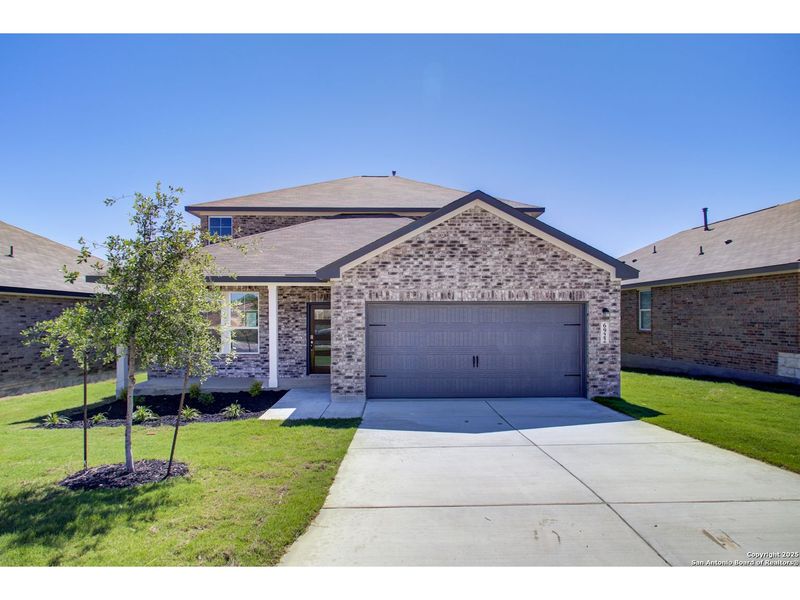 Front exterior of a new home in Comanche Ridge, San Antonio, TX, highlighting curb appeal (Image 1).