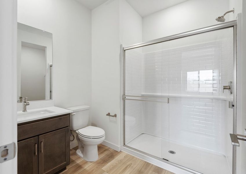 The master bathroom features a glass-enclosed shower.