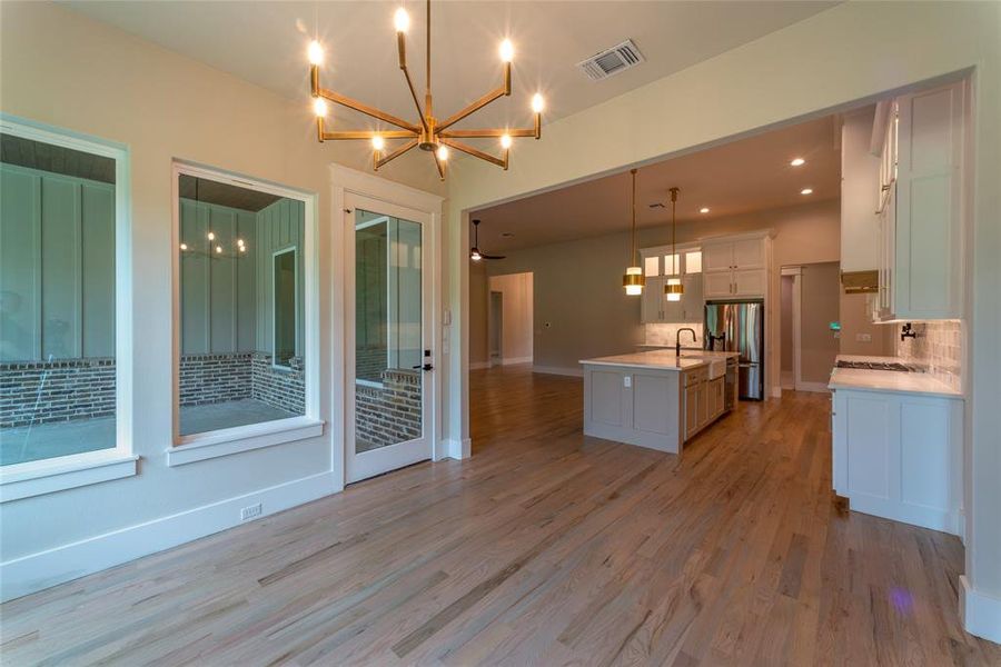 Dining room showing kitchen, large island and den.