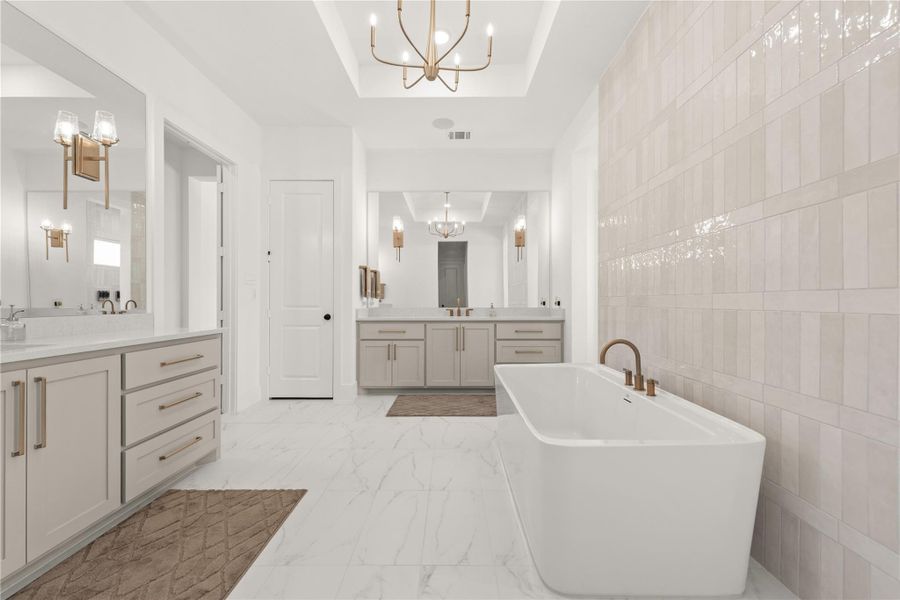 Luxurious primary retreat boasts neutral rich color palette.