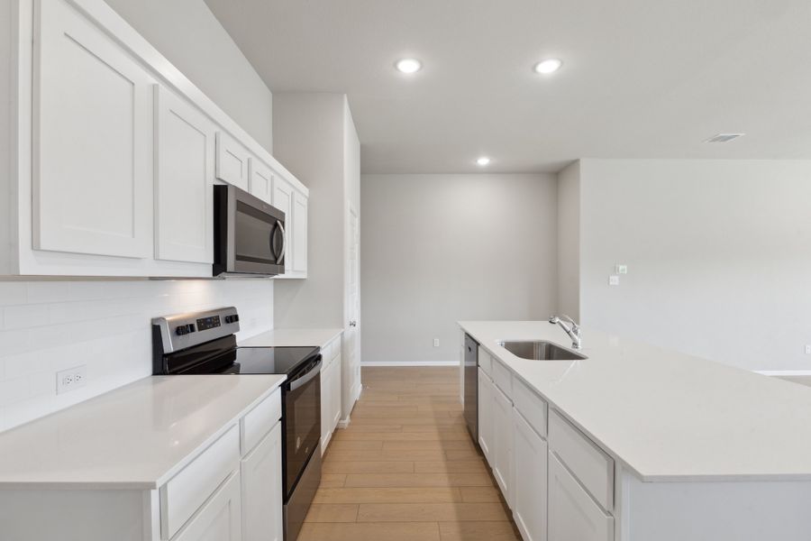 Kitchen in the Diamond home plan by Trophy Signature Homes – REPRESENTATIVE PHOTO