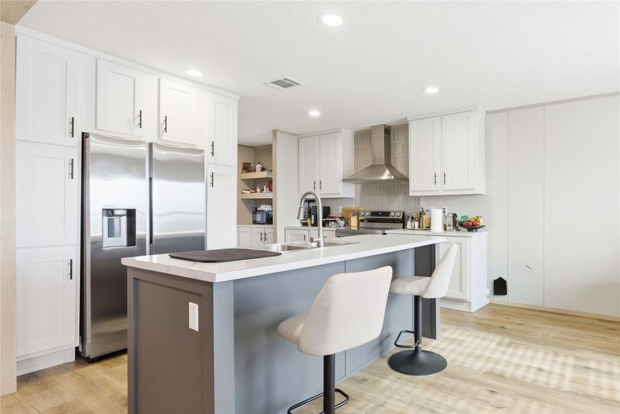 Modern kitchen with an inviting island and bright recessed lighting.