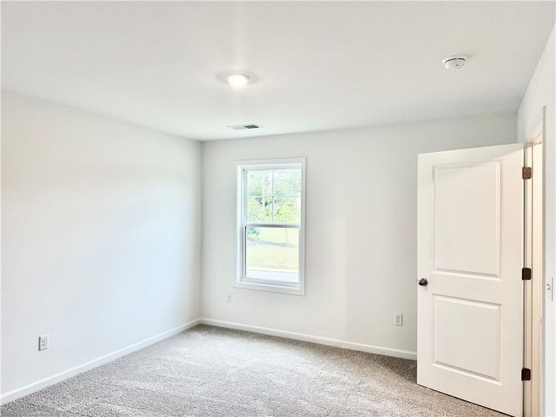 Plush carpeting and a classic sash window define t