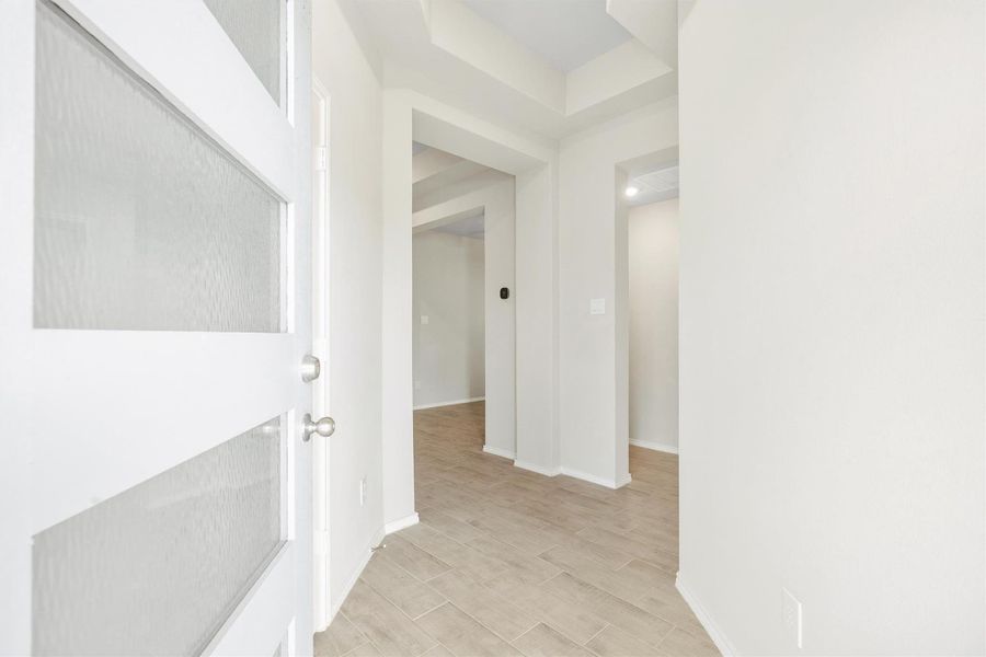 The moment you walk in, the tone is set. A bright, open foyer with high ceilings and wood-look tile flooring flows naturally into the heart of the home. The moment you walk in, the tone is set. A bright, open foyer with high ceilings and wood-look tile flooring flows naturally into the heart of the home.