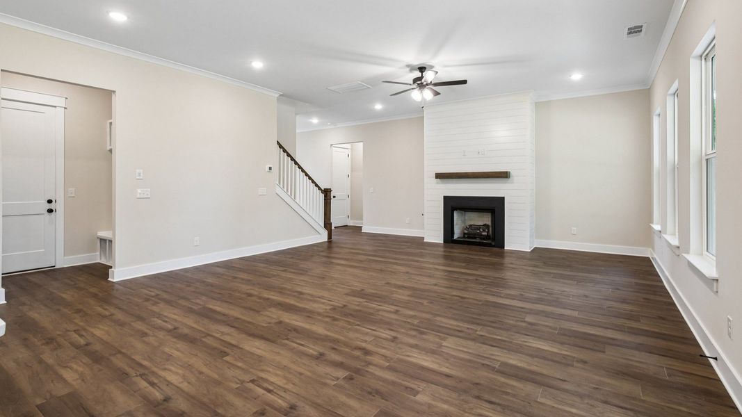 Gathering room with ceiling fan, fireplace, and hard surface flooring Gathering room with ceiling fan, fireplace, and hard surface flooring