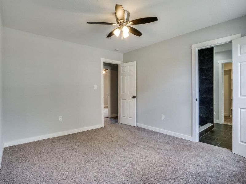 Unfurnished bedroom with ceiling fan and carpet floors Unfurnished bedroom with ceiling fan and carpet floors