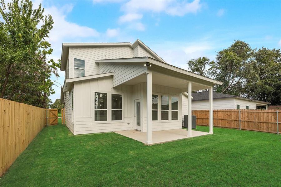 Back of house with a patio, board and batten siding, and a fenced backyard Back of house with a patio, board and batten siding, and a fenced backyard