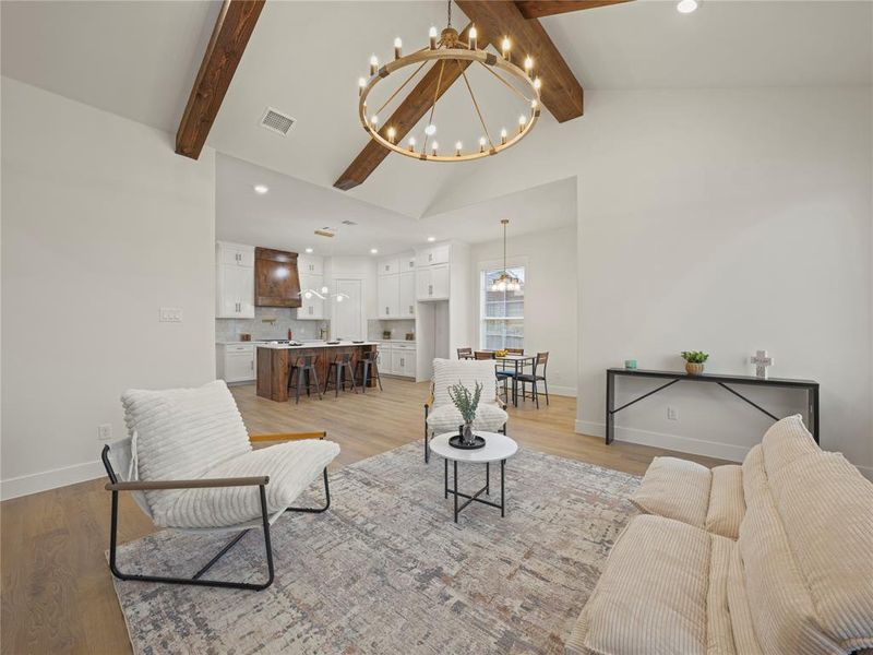 Living room with light wood-type flooring and a chandelier