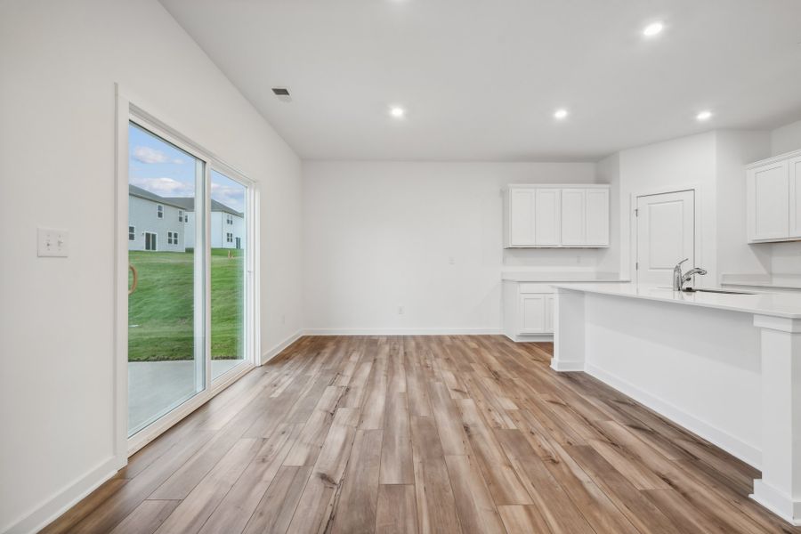 A kitchen with a wood floor. A kitchen with a wood floor.