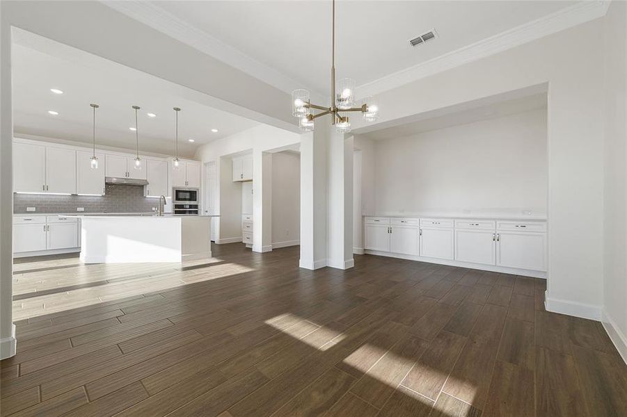 The dining room features a wall of cabinets, perfect for storage and entertaining.