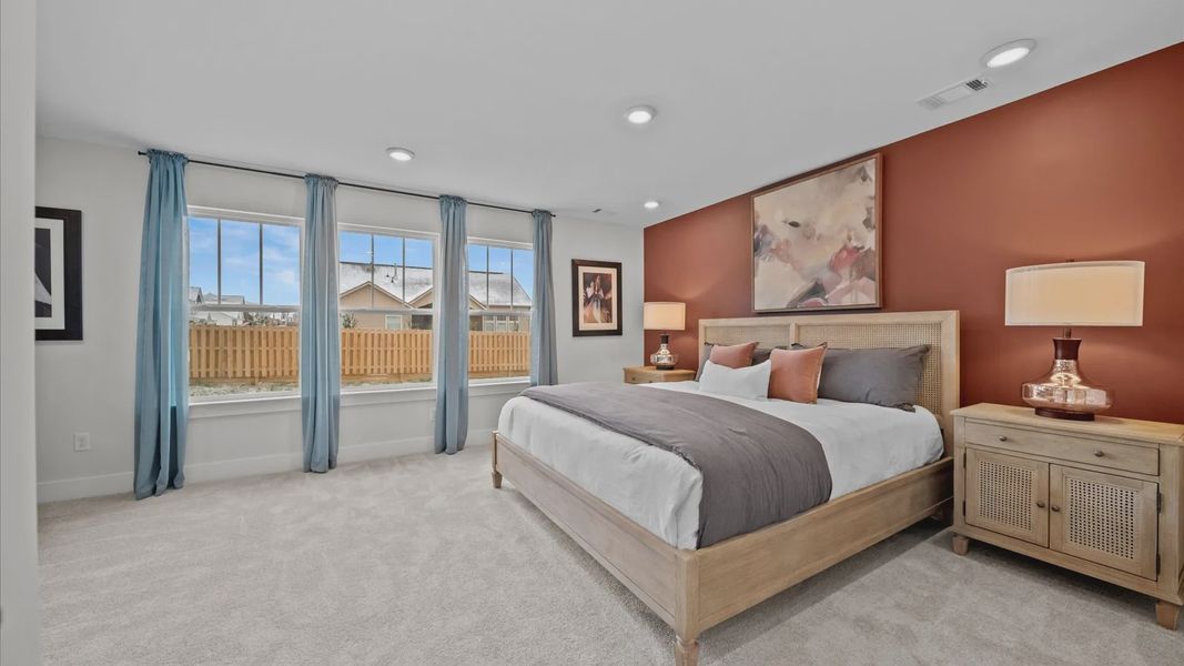 Vibrant natural light fills this exceptional primary bedroom with eye-catching details Vibrant natural light fills this exceptional primary bedroom with eye-catching details