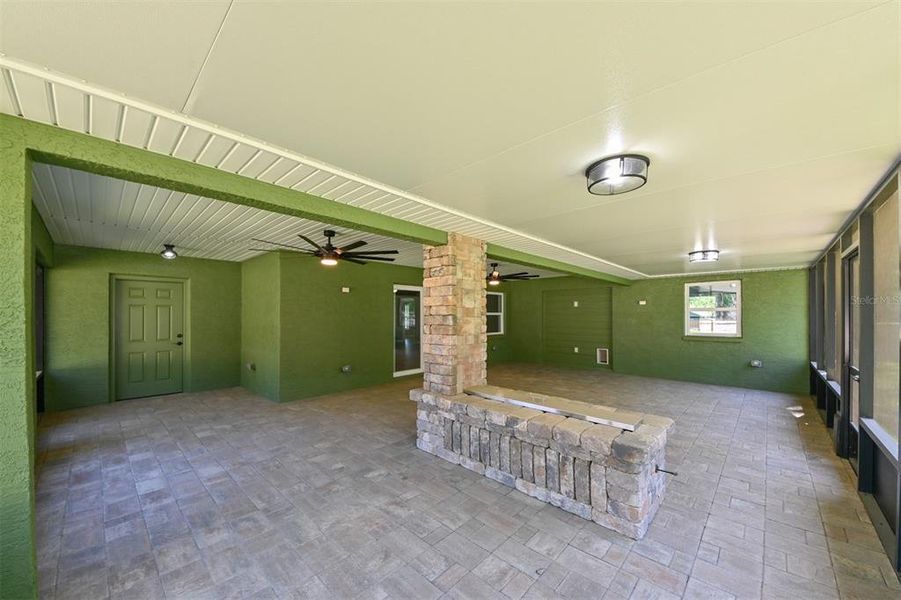 Spacious, paved patio with covered fireplace