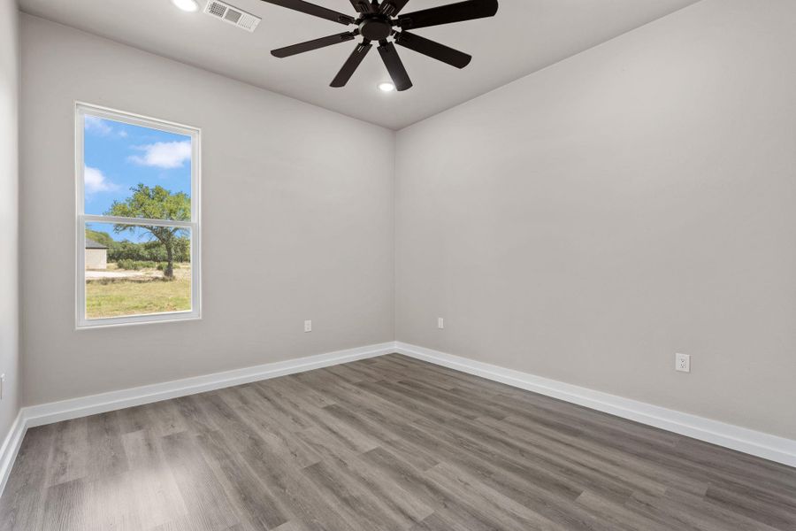 A well-lit room featuring durable wood-look flooring, offering comfort and practicality. A well-lit room featuring durable wood-look flooring, offering comfort and practicality.