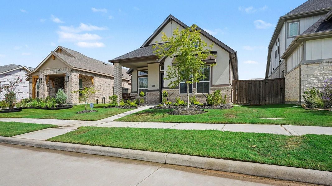 Front exterior of a new home in , Mont Belvieu, TX, highlighting curb appeal (Image 22).