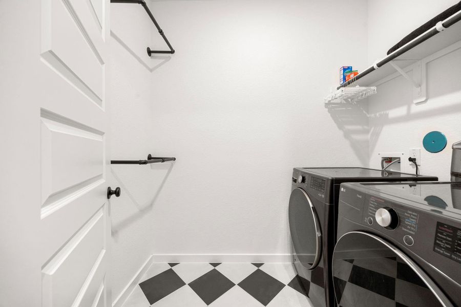 The utility room with plenty of storage space and gorgeous custom tile. You have gas and electric connections here. You also have an electrical panel to hide all wifi and other utilities for the home.