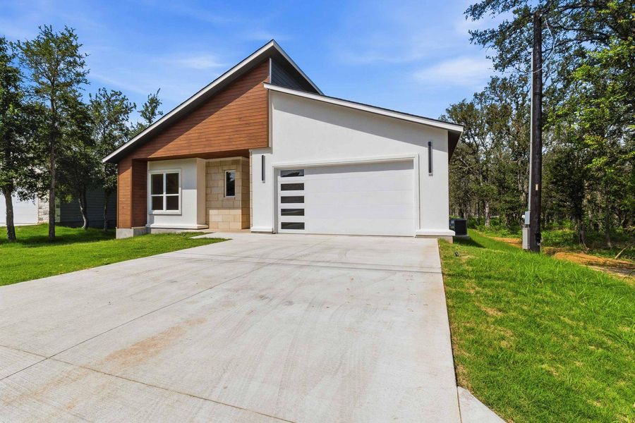 Front exterior of a new home in , Bastrop, TX, highlighting curb appeal (Image 1). Front exterior of a new home in , Bastrop, TX, highlighting curb appeal (Image 1).