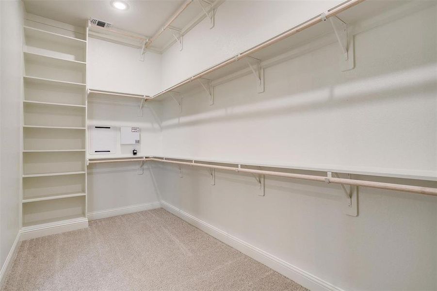 Huge primRy closet with built in shelving.