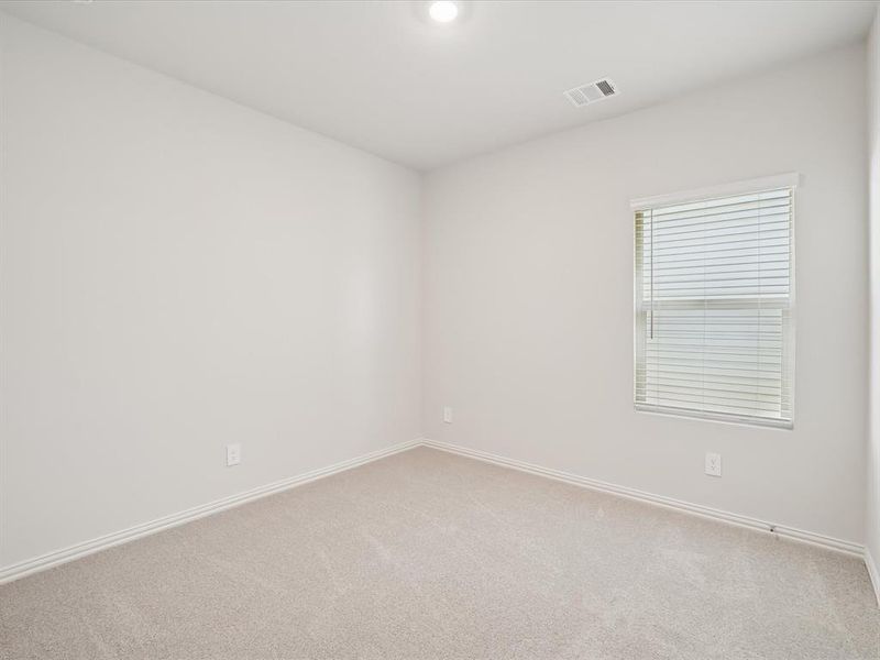 Carpeted spare room with baseboards