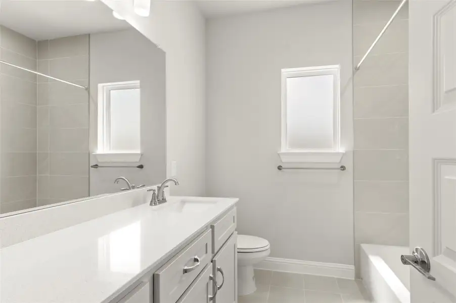 Bathroom with vanity, tile patterned floors, and bathtub / shower combination Bathroom with vanity, tile patterned floors, and bathtub / shower combination