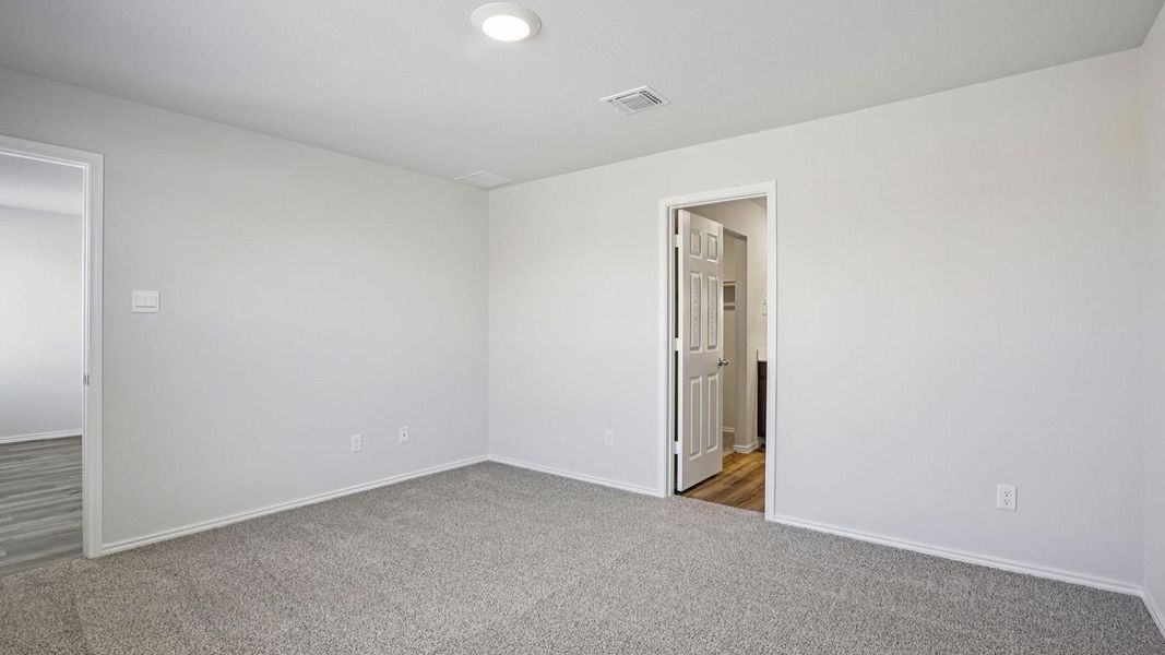Carpeted spare room with baseboards