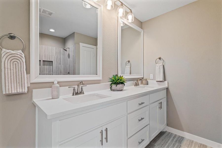 Bathroom featuring vanity and a shower