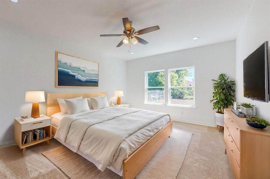 Virtually Staged - Primary Bedroom featuring ceiling fan and light carpet