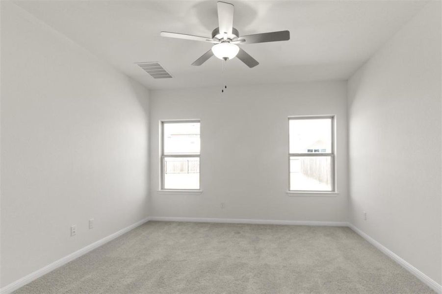 Empty room featuring baseboards, ceiling fan, visible vents, and light colored carpet