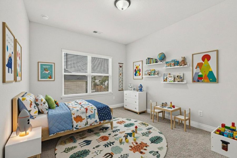 Bedroom with light colored carpet and baseboards