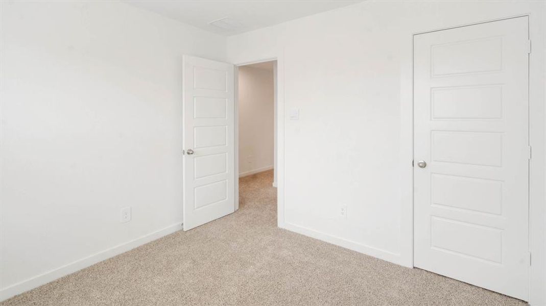Empty room featuring carpet flooring and baseboards