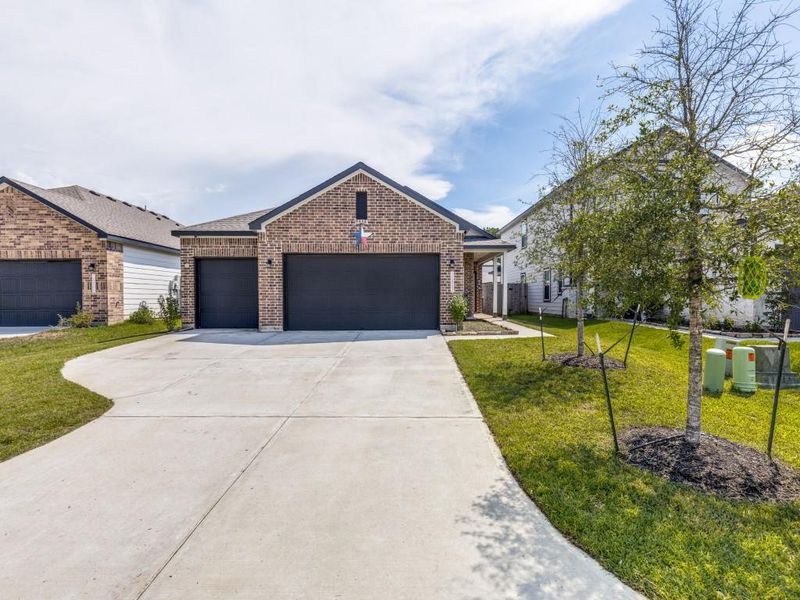 Front exterior of a new home in , Conroe, TX, highlighting curb appeal (Image 21).