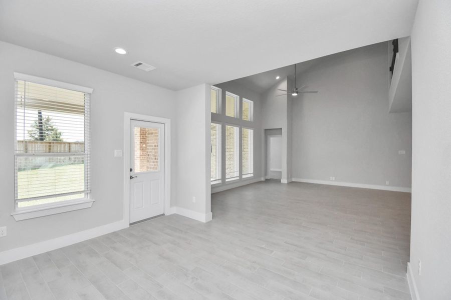 Make memories gathered around the table with your family and friends! This spacious dining room features elegant flooring, custom paint, and adjacent to family room and kitchen for open concept feel. Sample photo of completed home with similar floor plan. Actual colors and selections may vary.
