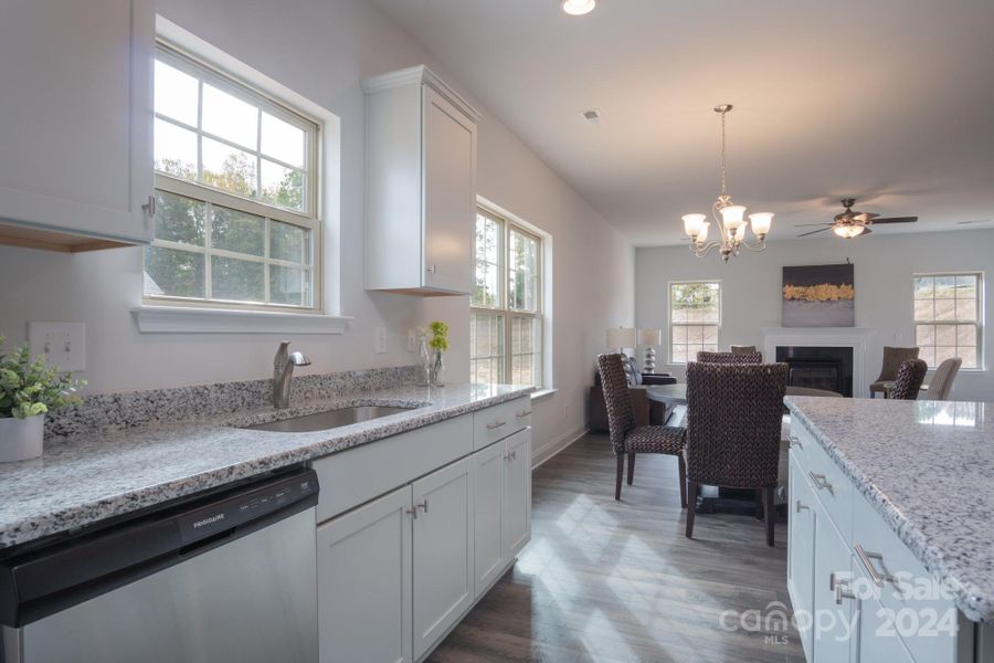 Kitchen into Breakfast Area. Photo representation. Colors and options will differ.