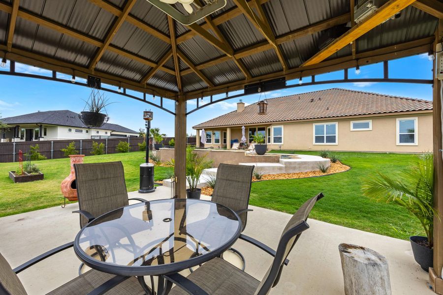 Enjoy outdoor gatherings under the covered patio, extending to a well-maintained yard and the home's warm exterior. Enjoy outdoor gatherings under the covered patio, extending to a well-maintained yard and the home's warm exterior.