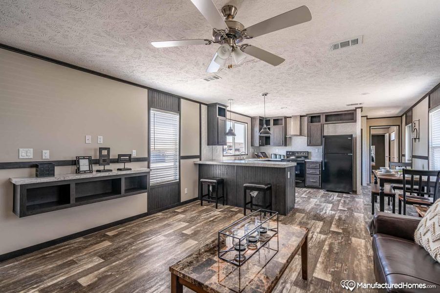 An open concept living area seamlessly blends the kitchen, dining, and living spaces for modern living.