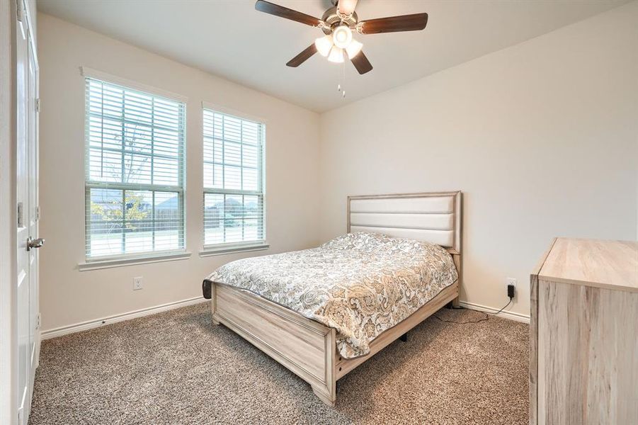 Bedroom featuring carpet flooring and a ceiling fan Bedroom featuring carpet flooring and a ceiling fan